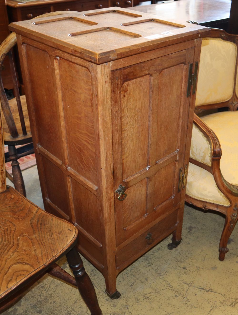 An Arts & Crafts panelled oak bedside cupboard, W.41cm